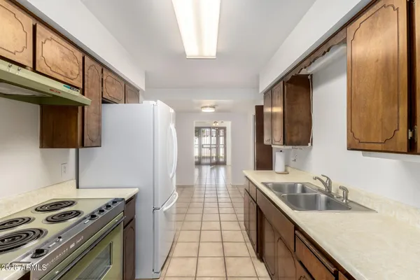 a kitchen with a refrigerator sink and stove