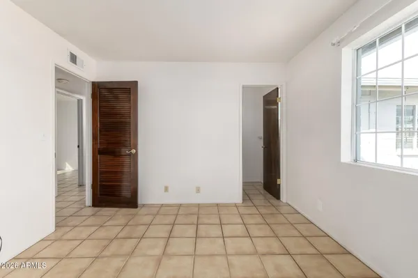 a view of a room with a fan and a window