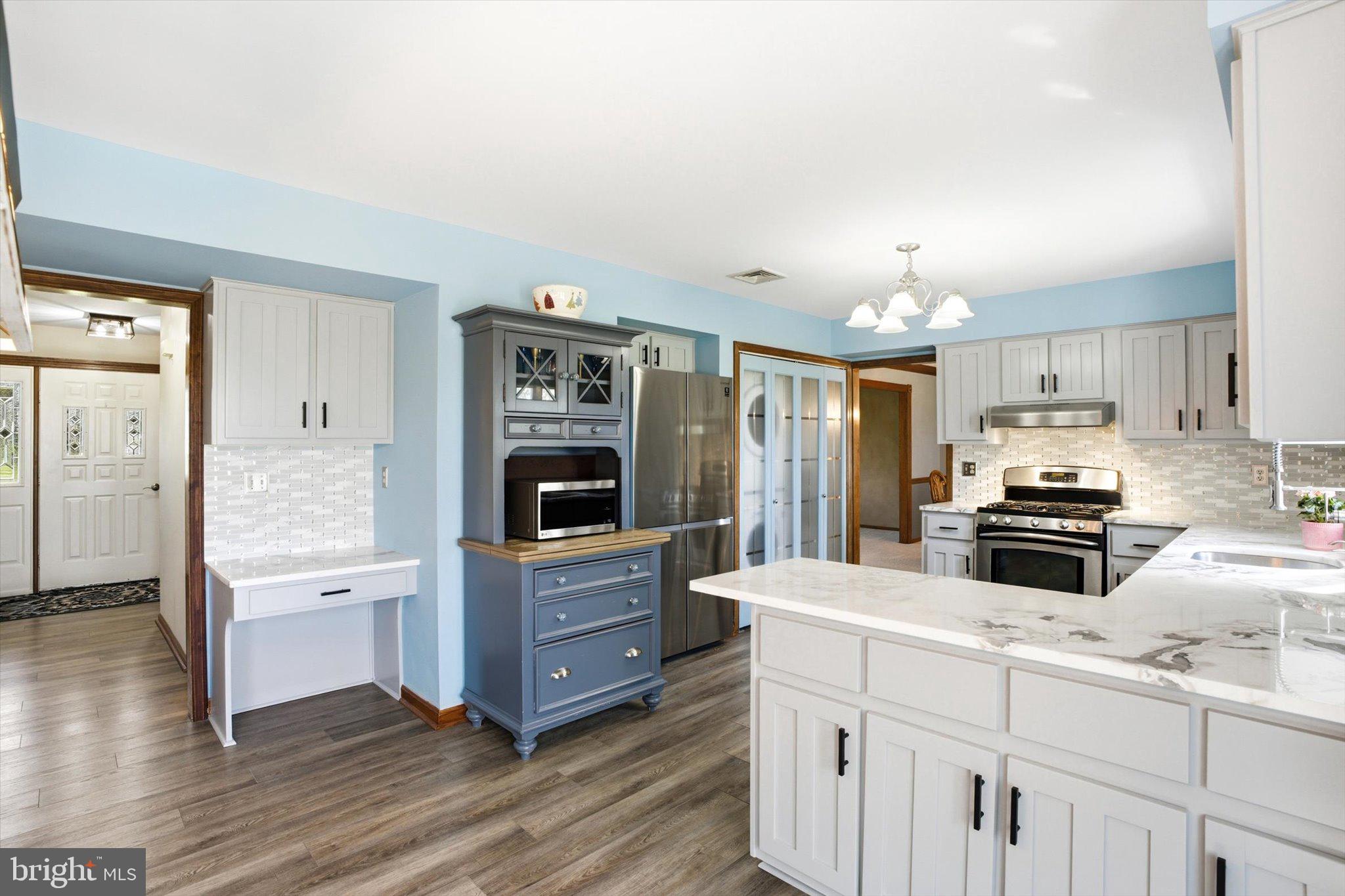 25446 Mt Pleasant Road Columbus, NJ 08022 - Photo 15 of 32 a kitchen with kitchen island granite countertop a stove cabinets and wooden floor