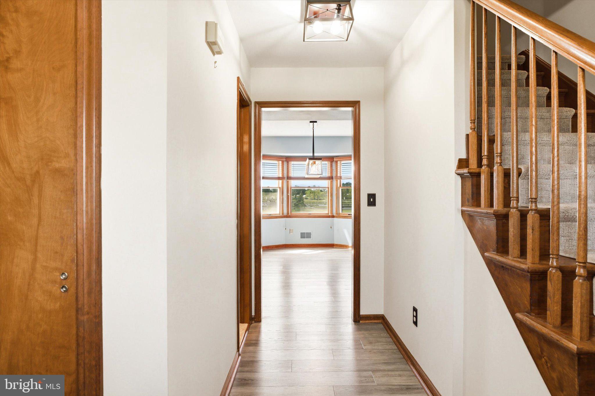 25446 Mt Pleasant Road Columbus, NJ 08022 - Photo 4 of 32 a view of a hallway with wooden floor and staircase
