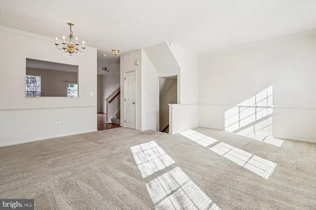 a view of a bedroom with a chandelier fan and windows