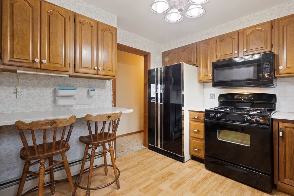 29 Taft Avenue Beverly, MA 01915 - Photo 11 of 41 a kitchen with stainless steel appliances a stove a sink refrigerator and microwave