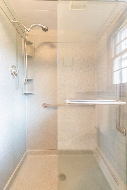 29 Taft Avenue Beverly, MA 01915 - Photo 27 of 41 a bathroom with a glass shower door