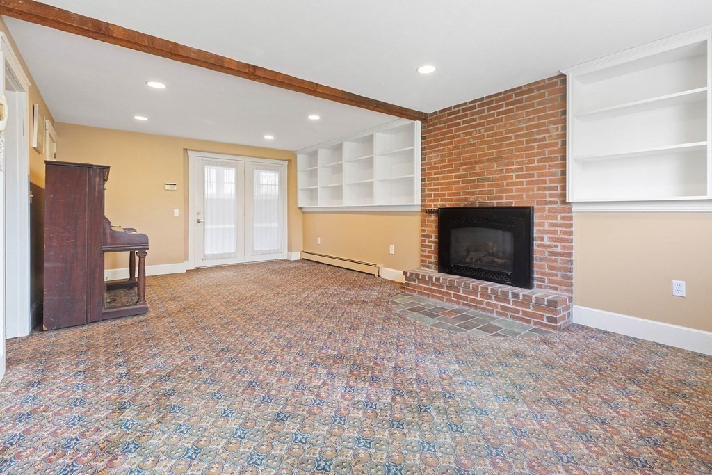 29 Taft Avenue Beverly, MA 01915 - Photo 28 of 41 an empty room with furniture and a fireplace