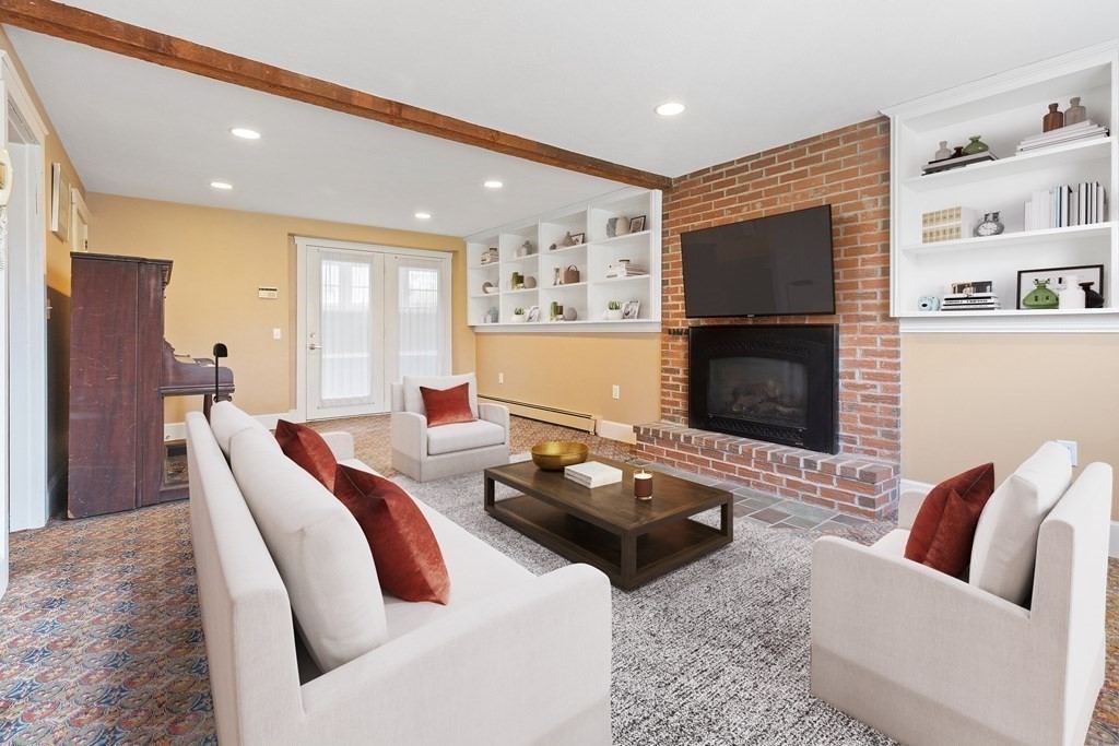29 Taft Avenue Beverly, MA 01915 - Photo 29 of 41 a living room with furniture a flat screen tv and a fireplace