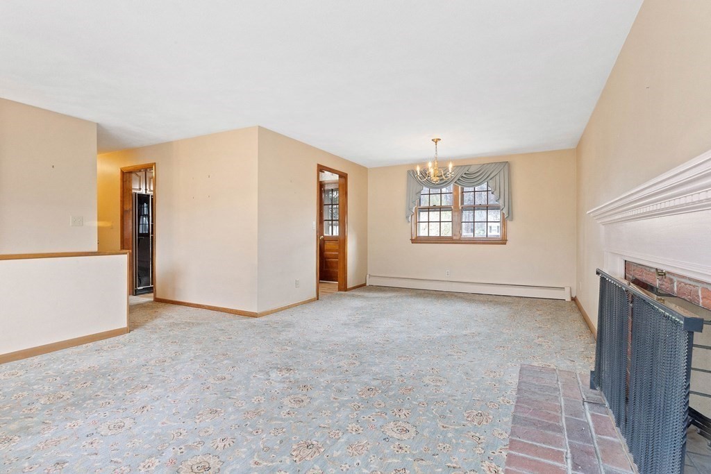 29 Taft Avenue Beverly, MA 01915 - Photo 4 of 41 an empty room with windows and fireplace