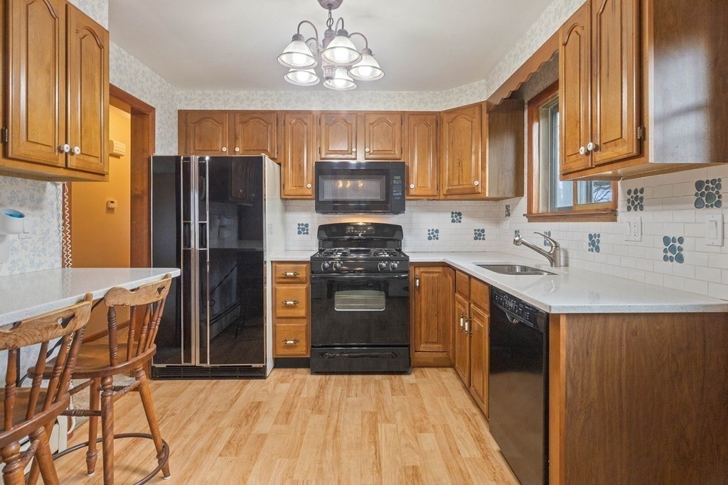 29 Taft Avenue Beverly, MA 01915 - Photo 9 of 41 a kitchen with stainless steel appliances a stove refrigerator sink and cabinets