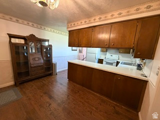 588 North 4500 West West Point, UT 84015 - Photo 15 of 61 Wood-finish flooring throughout, featuring a kitchen peninsula with wood cabinetry and a light-colored countertop