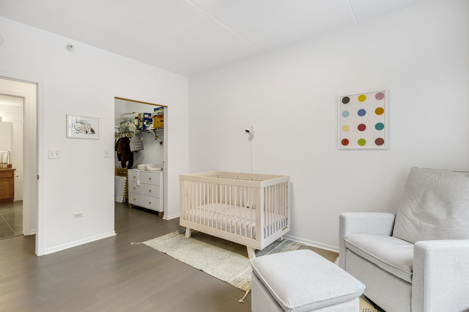 515 Main Street, Unit 308 Evanston, IL 60202 - Photo 15 of 19 a living room with furniture and a baby crib