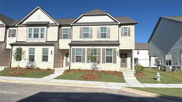 a front view of house with yard and green space