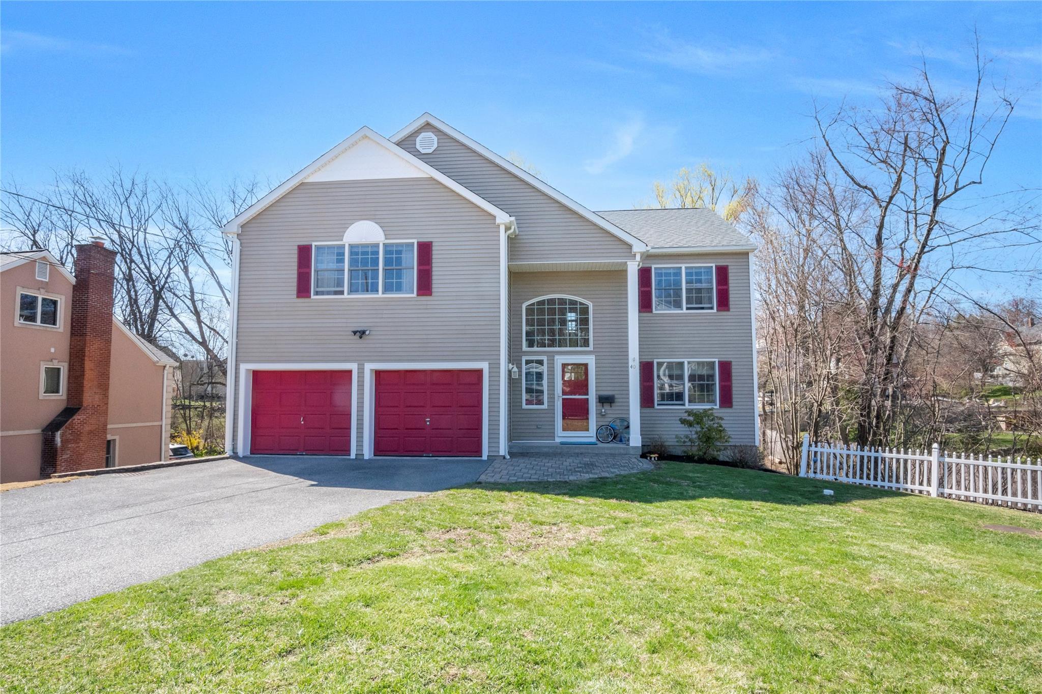 a front view of building with yard and trees