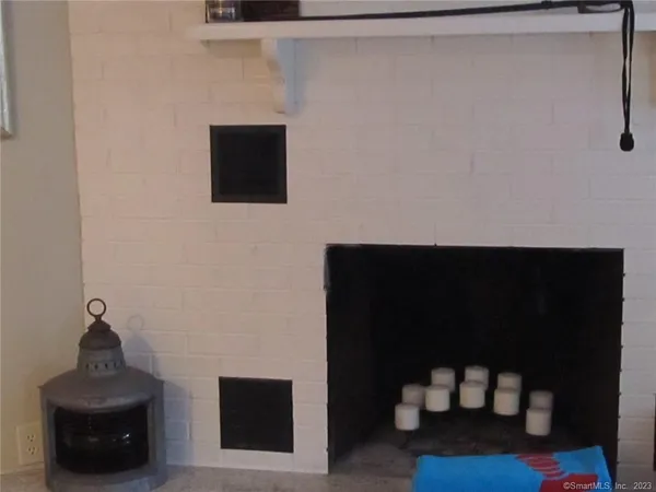 a view of a small living room with a sink and a mirror