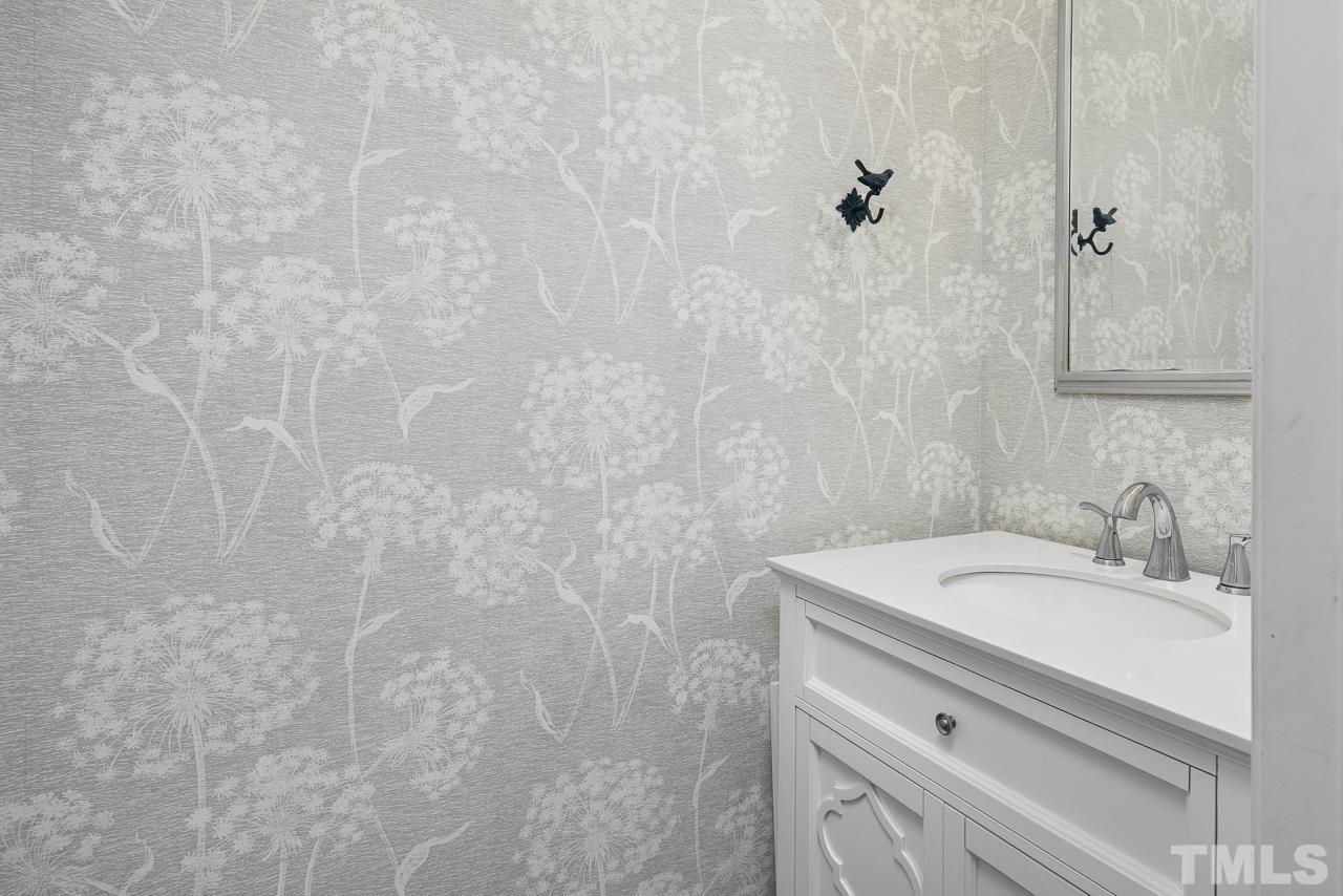 4422 Vienna Crest Drive Raleigh, NC 27613 - Photo 11 of 28 a bathroom with a sink a vanity and a mirror