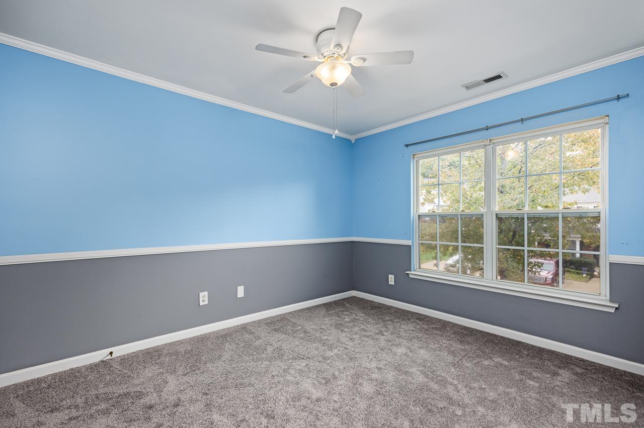 4422 Vienna Crest Drive Raleigh, NC 27613 - Photo 17 of 28 an empty room with windows and ceiling fan