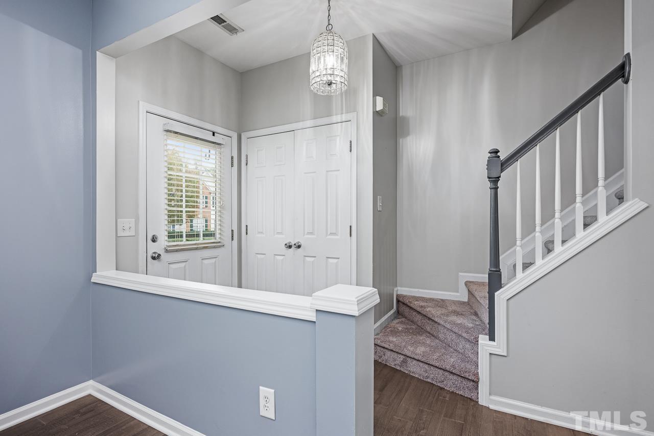 4422 Vienna Crest Drive Raleigh, NC 27613 - Photo 2 of 28 a view of a hallway with wooden floor and staircase