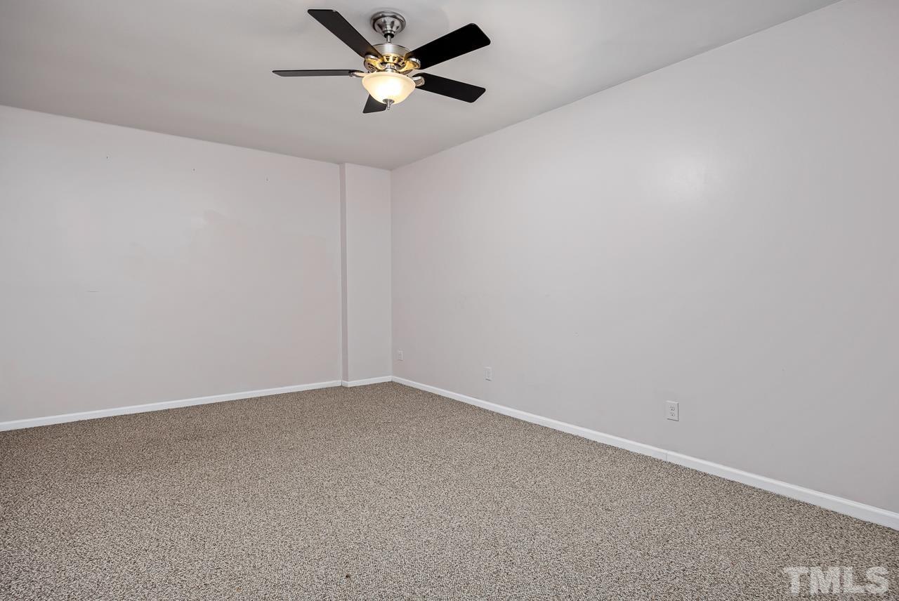 4422 Vienna Crest Drive Raleigh, NC 27613 - Photo 23 of 28 an empty room with a empty space and a ceiling fan