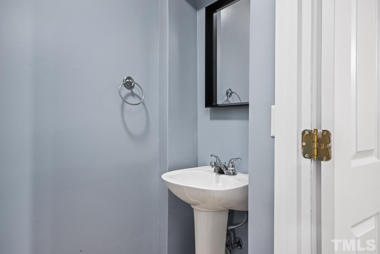 4422 Vienna Crest Drive Raleigh, NC 27613 - Photo 24 of 28 a bathroom with a sink and mirror