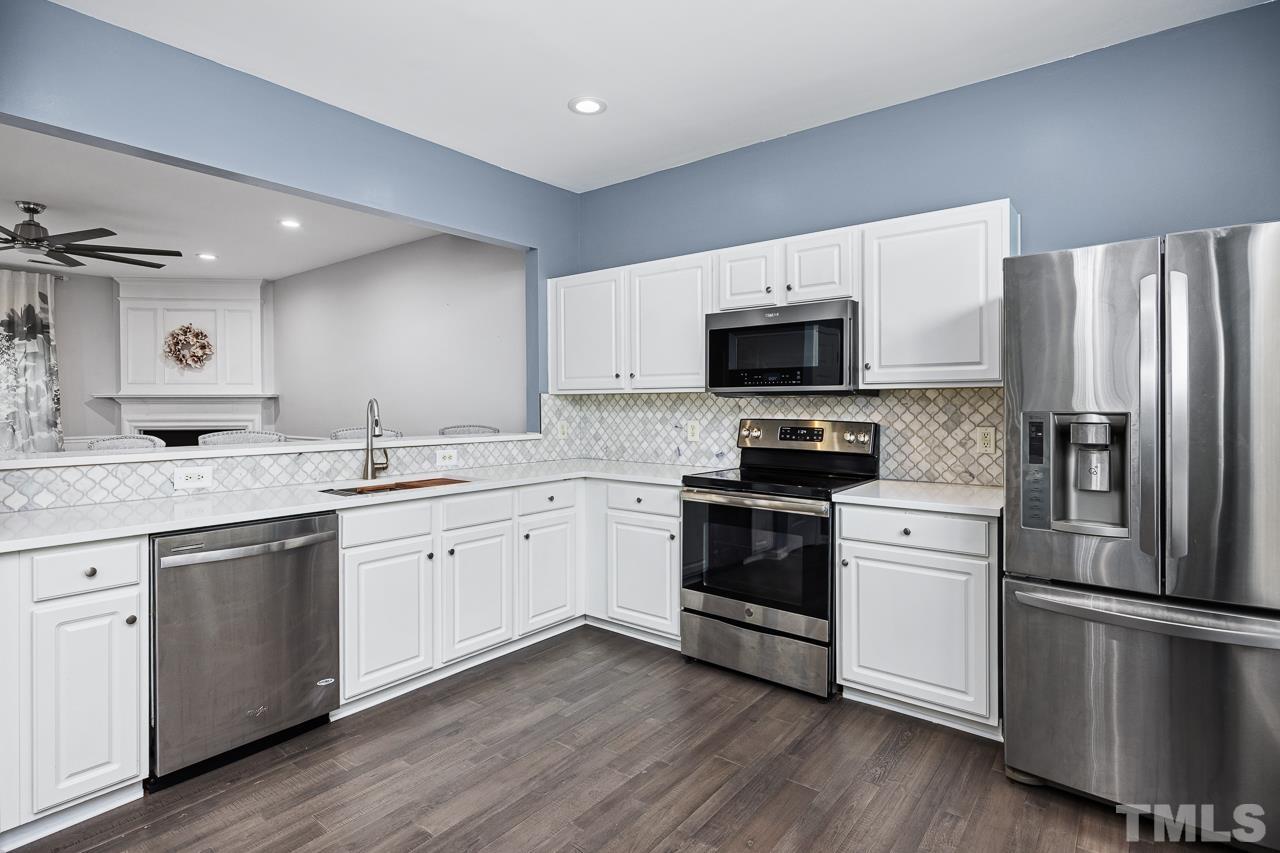 4422 Vienna Crest Drive Raleigh, NC 27613 - Photo 4 of 28 a kitchen with granite countertop a refrigerator stove top oven and sink
