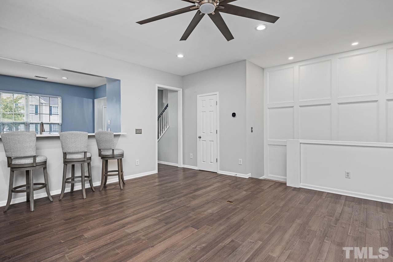 4422 Vienna Crest Drive Raleigh, NC 27613 - Photo 7 of 28 a view of a livingroom with furniture wooden floor and a ceiling fan