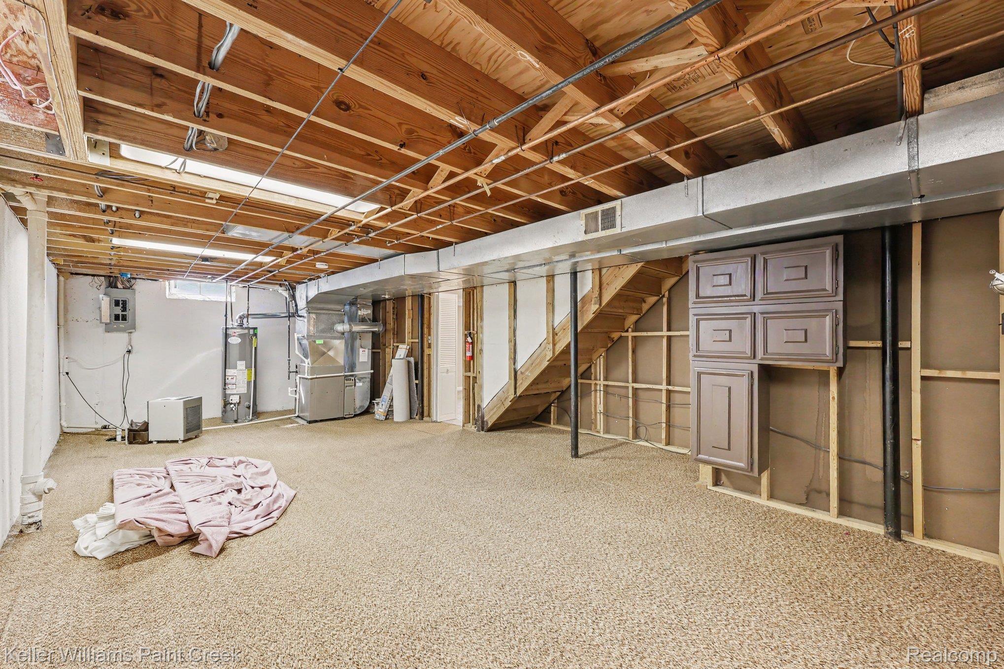 2717 Powderhorn Ridge Road Rochester, MI 48309 - Photo 30 of 48 Open unfinished basement area with exposed wood ceiling joists and wall studs