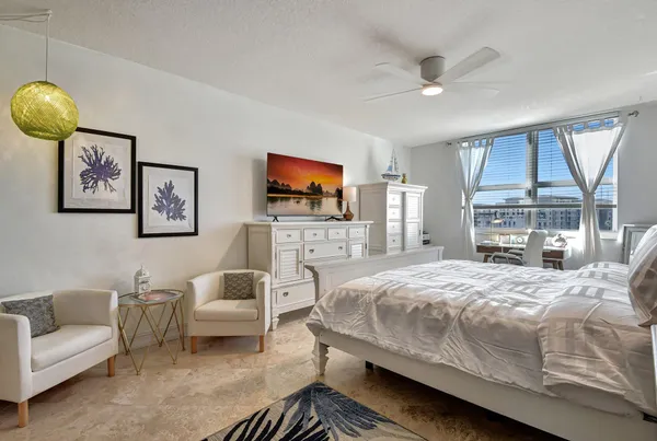 a bedroom with a bed and a flat screen tv