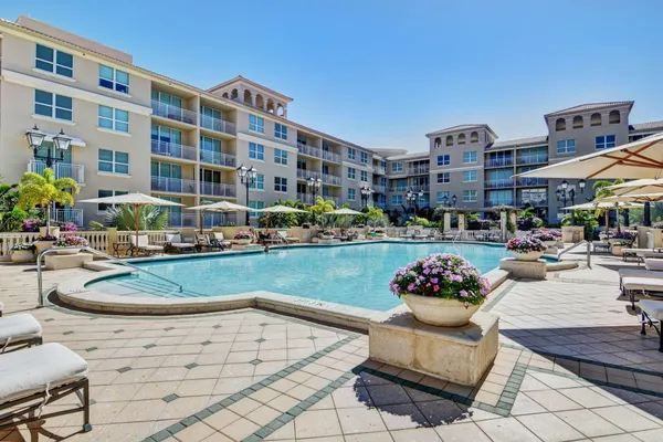 a view of a swimming pool with outdoor seating
