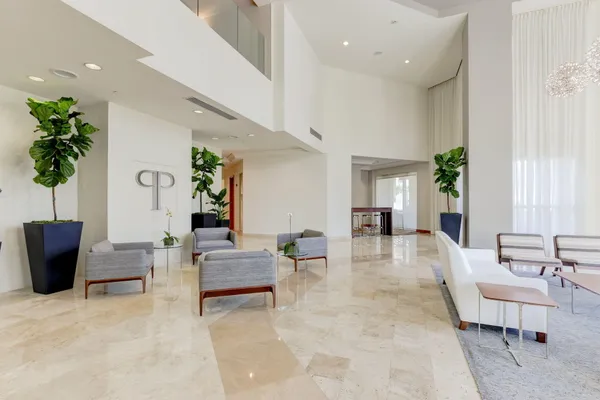 a living room with furniture and a potted plant