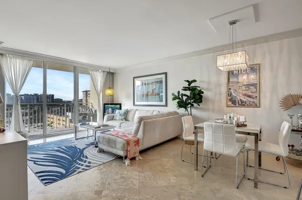a bedroom with furniture and a large window