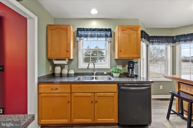 a kitchen with a sink cabinets and window