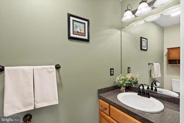 a bathroom with a sink vanity and a mirror