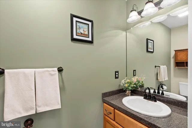 a bathroom with a sink vanity and a mirror