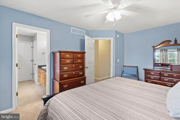 a bedroom with a bed and a dresser