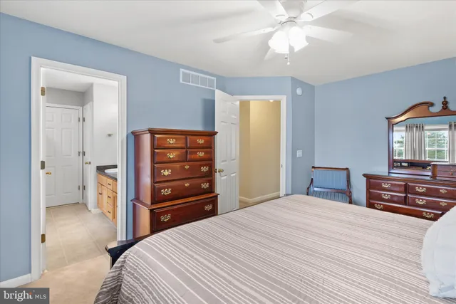 a bedroom with a bed and a dresser