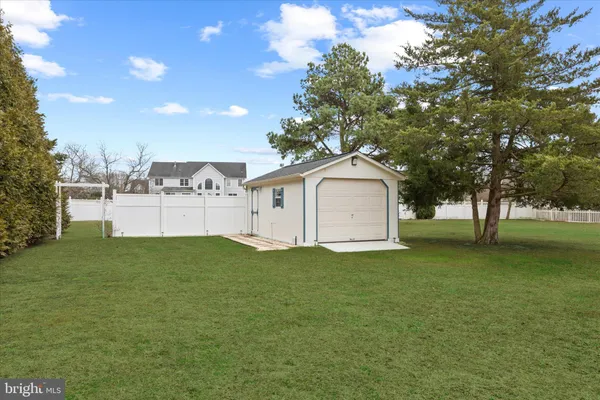 a large white house with a big yard and large trees
