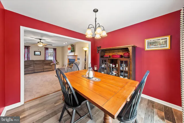 a view of a dining room with furniture wooden floor and chandelier