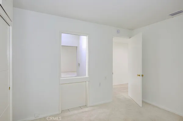 a bathroom with a granite countertop sink a toilet and a mirror