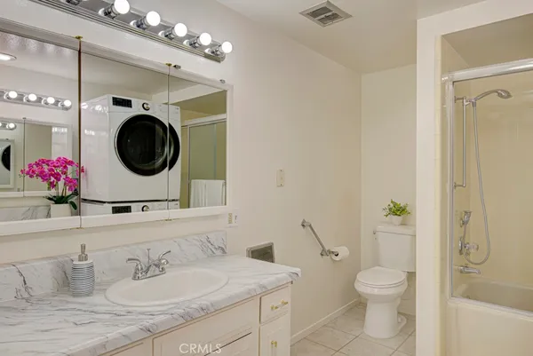 a view of a storage and utility room with washer and dryer