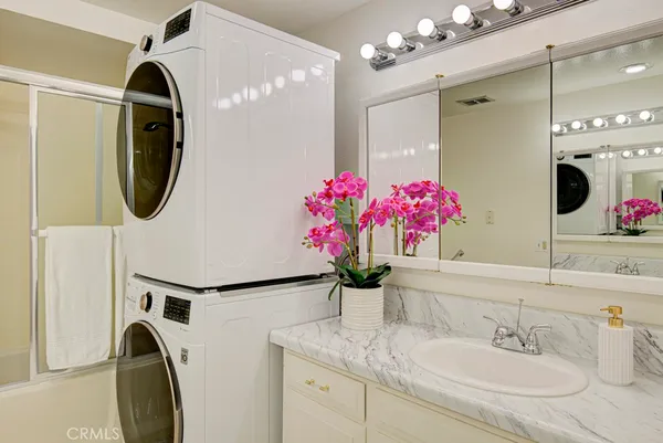a bathroom with a sink double vanity and a mirror