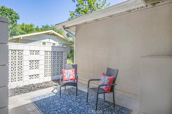 a balcony with table and chairs