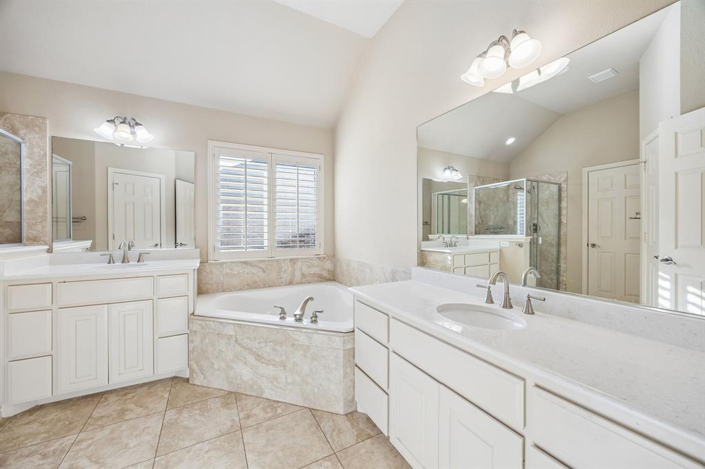 676 Scenic Ranch Circle Fairview, TX 75069 - Photo 14 of 30 a bathroom with a tub sink double vanity and a mirror