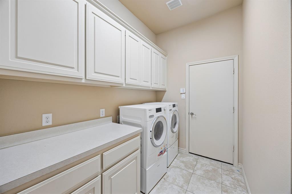 676 Scenic Ranch Circle Fairview, TX 75069 - Photo 19 of 30 a utility room with dryer and washer