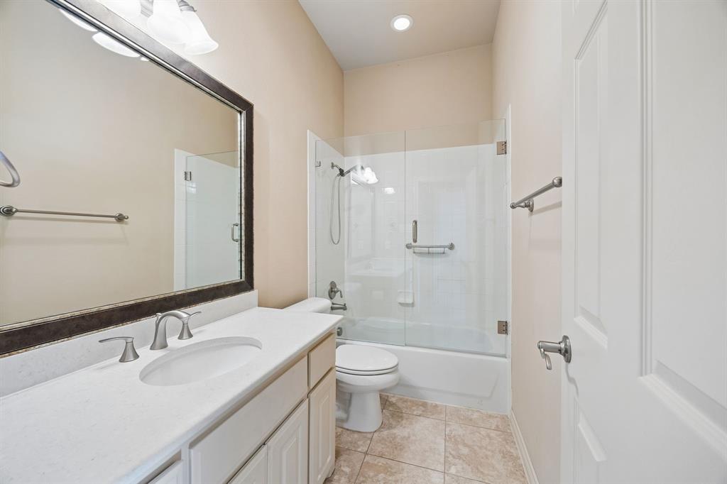 676 Scenic Ranch Circle Fairview, TX 75069 - Photo 20 of 30 a bathroom with a granite countertop sink a toilet and shower