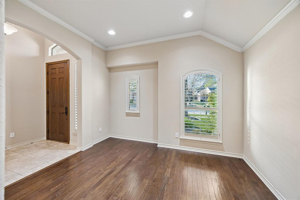676 Scenic Ranch Circle Fairview, TX 75069 - Photo 4 of 30 an empty room with wooden floor and windows