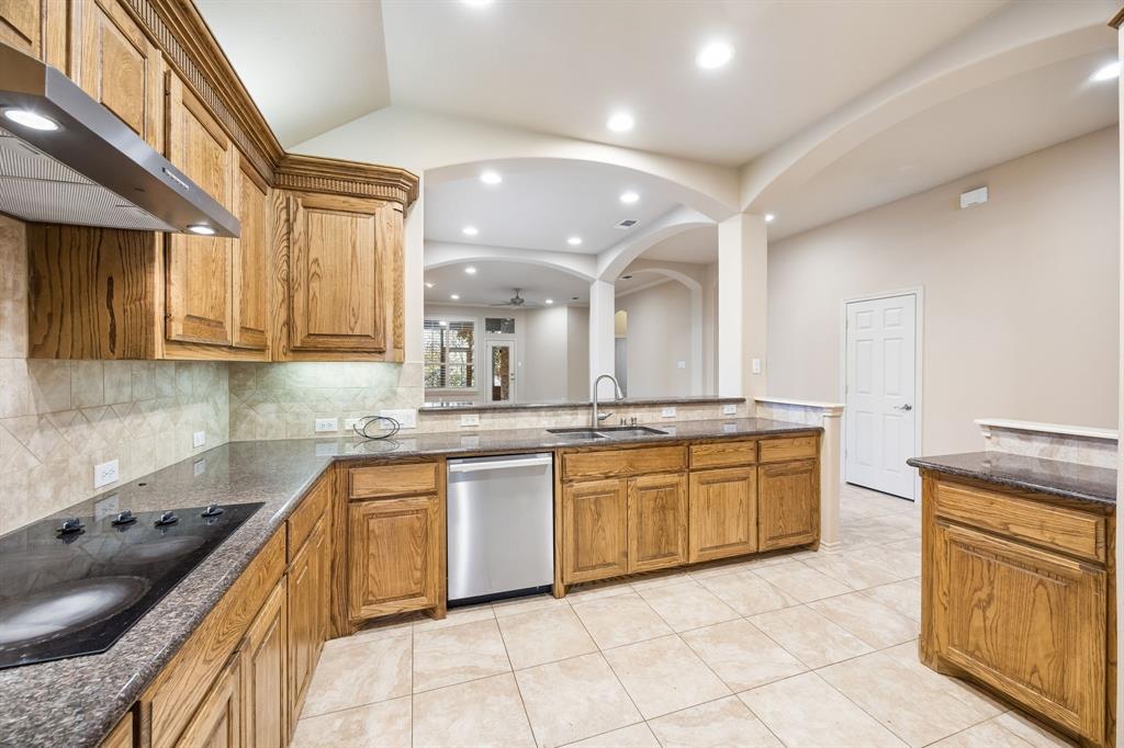 676 Scenic Ranch Circle Fairview, TX 75069 - Photo 8 of 30 a large kitchen with stainless steel appliances granite countertop a sink and cabinets