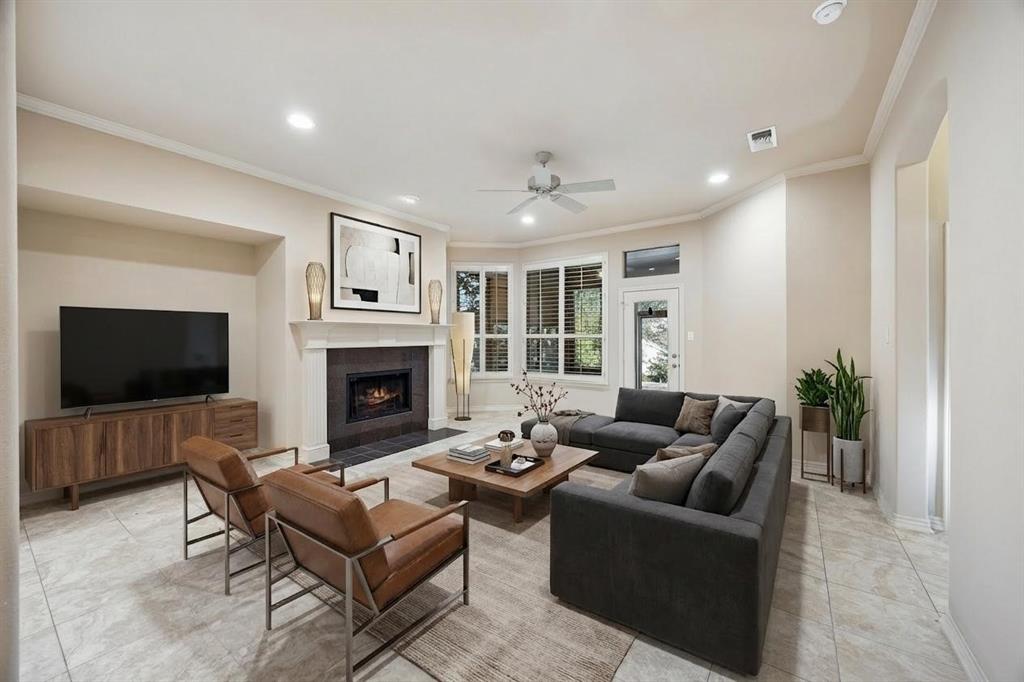 676 Scenic Ranch Circle Fairview, TX 75069 - Photo 10 of 30 a living room with furniture a flat screen tv and a fireplace