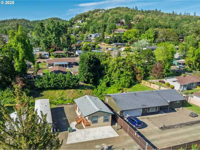 an aerial view of a house with swimming pool garden and patio