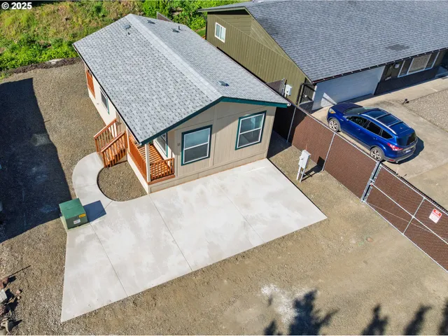 an aerial view of a house with swimming pool and sitting space