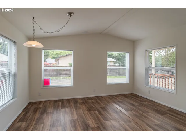 a room that has a window and wooden floor