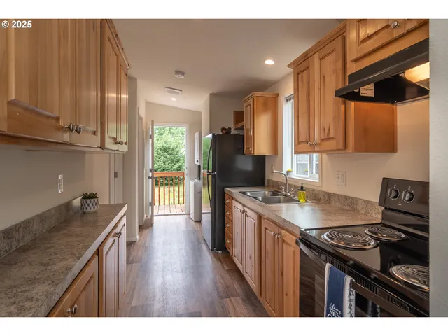 a kitchen with a stove a sink and a refrigerator
