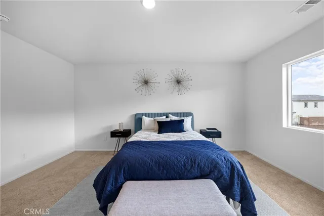 a bedroom with a bed and window